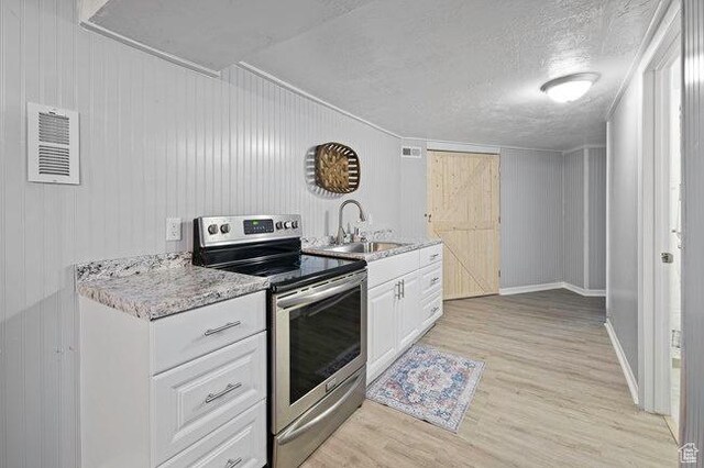 575 N 300 E, Tremonton, UT 84337 - kitchen featuring a sink, light wood-style floors, stainless steel electric range, visible vents, and white cabinets