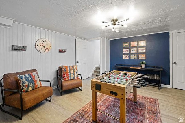 575 N 300 E, Tremonton, UT 84337 - rec room with a textured ceiling, wood finished floors, and baseboards