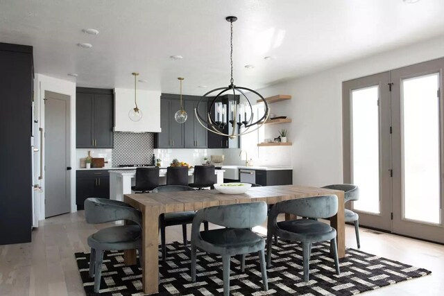 5291 W 3775 S Unit 22, Hooper, UT 84315 - kitchen featuring sink, tasteful backsplash, a chandelier, hanging light fixtures, and light wood-type flooring