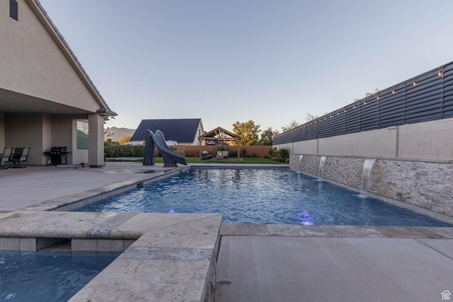 717 S 775 W, Hurricane, UT 84737 - view of swimming pool with a water slide, a grill, and a patio area