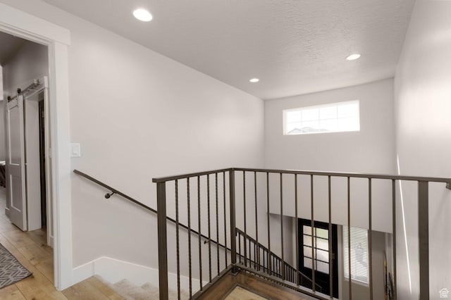 717 S 775 W, Hurricane, UT 84737 - staircase featuring hardwood / wood-style flooring, a barn door, and a textured ceiling