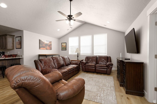 717 S 775 W, Hurricane, UT 84737 - living room featuring ceiling fan, lofted ceiling, light hardwood / wood-style flooring, and a textured ceiling