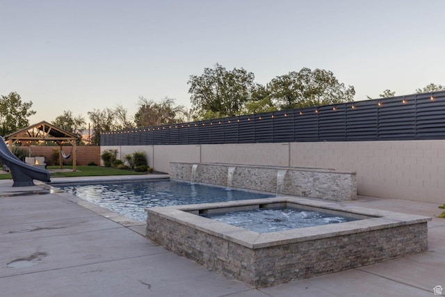 717 S 775 W, Hurricane, UT 84737 - pool at dusk with a water slide, a gazebo, and an in ground hot tub