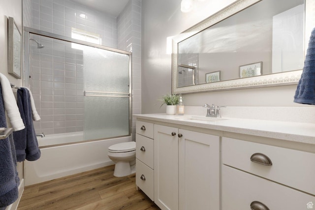 717 S 775 W, Hurricane, UT 84737 - full bathroom with vanity, hardwood / wood-style floors, enclosed tub / shower combo, and toilet