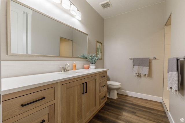 717 S 775 W, Hurricane, UT 84737 - bathroom featuring vanity, decorative backsplash, wood-type flooring, and toilet