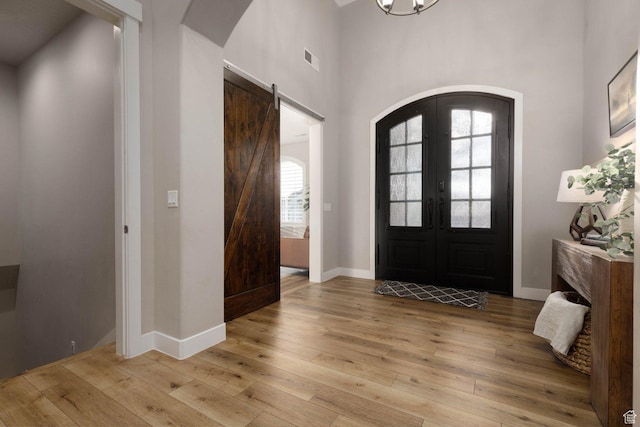 717 S 775 W, Hurricane, UT 84737 - foyer entrance featuring french doors, a towering ceiling, a barn door, and light wood-type flooring
