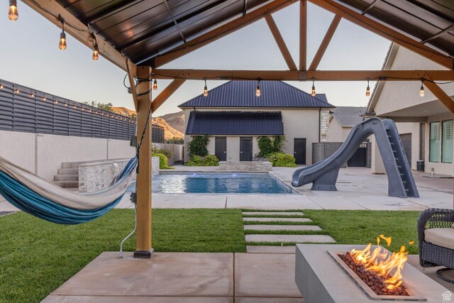 717 S 775 W, Hurricane, UT 84737 - view of pool featuring a patio, a water slide, an outdoor structure, and a fire pit
