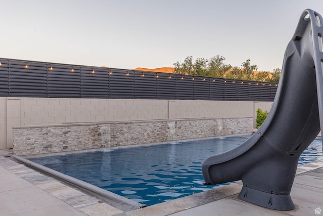 717 S 775 W, Hurricane, UT 84737 - pool at dusk featuring pool water feature