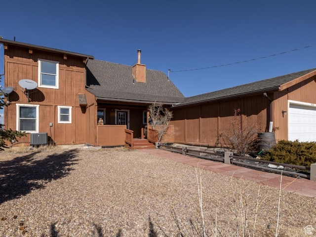 9742 S Crk 29, Duchesne, UT 84021 - view of front of house with an attached garage, roof with shingles, and a chimney