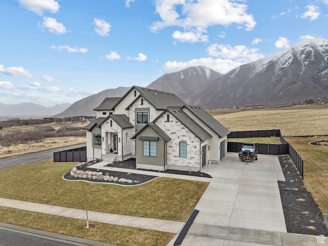 310 S Autumn Blaze Cir, Woodland Hills, UT 84653 - view of front of house featuring a garage, a mountain view, and a front lawn