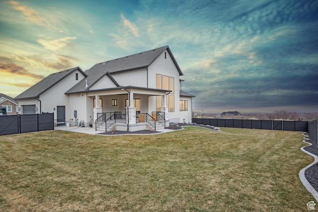 310 S Autumn Blaze Cir, Woodland Hills, UT 84653 - back house at dusk with a yard and a patio