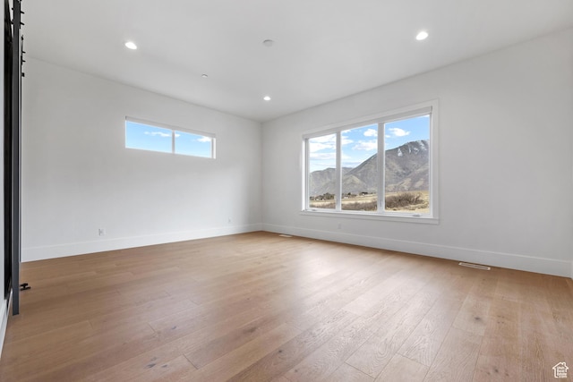 310 S Autumn Blaze Cir, Woodland Hills, UT 84653 - spare room featuring a mountain view, light hardwood / wood-style flooring, and a wealth of natural light