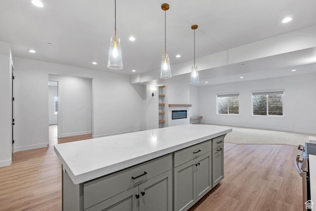 310 S Autumn Blaze Cir, Woodland Hills, UT 84653 - kitchen featuring stainless steel range, light wood-type flooring, hanging light fixtures, and gray cabinetry