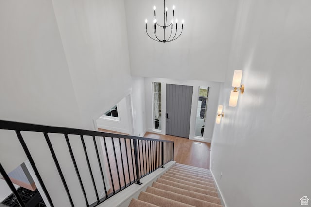 310 S Autumn Blaze Cir, Woodland Hills, UT 84653 - staircase featuring an inviting chandelier, hardwood / wood-style floors, and a towering ceiling