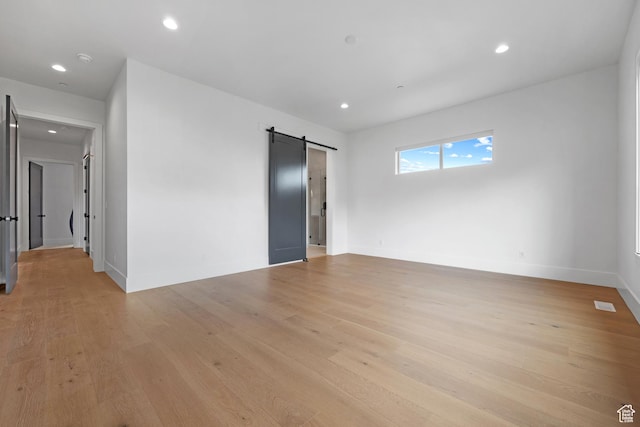 310 S Autumn Blaze Cir, Woodland Hills, UT 84653 - spare room featuring a barn door and light wood-type flooring