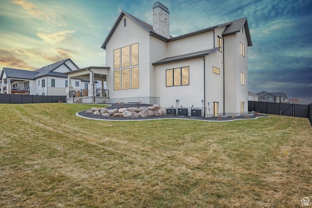 310 S Autumn Blaze Cir, Woodland Hills, UT 84653 - back house at dusk featuring a lawn