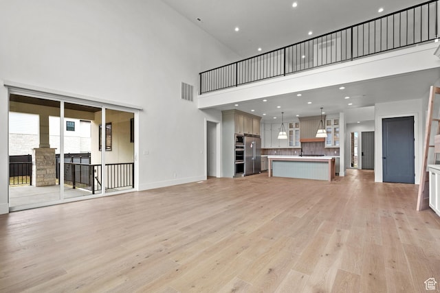 310 S Autumn Blaze Cir, Woodland Hills, UT 84653 - unfurnished living room with a high ceiling and light wood-type flooring