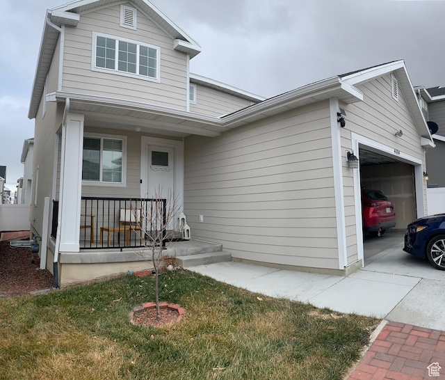 4694 E Lake Corner Dr, Eagle Mountain, UT 84005 - traditional home with a porch, concrete driveway, and a garage