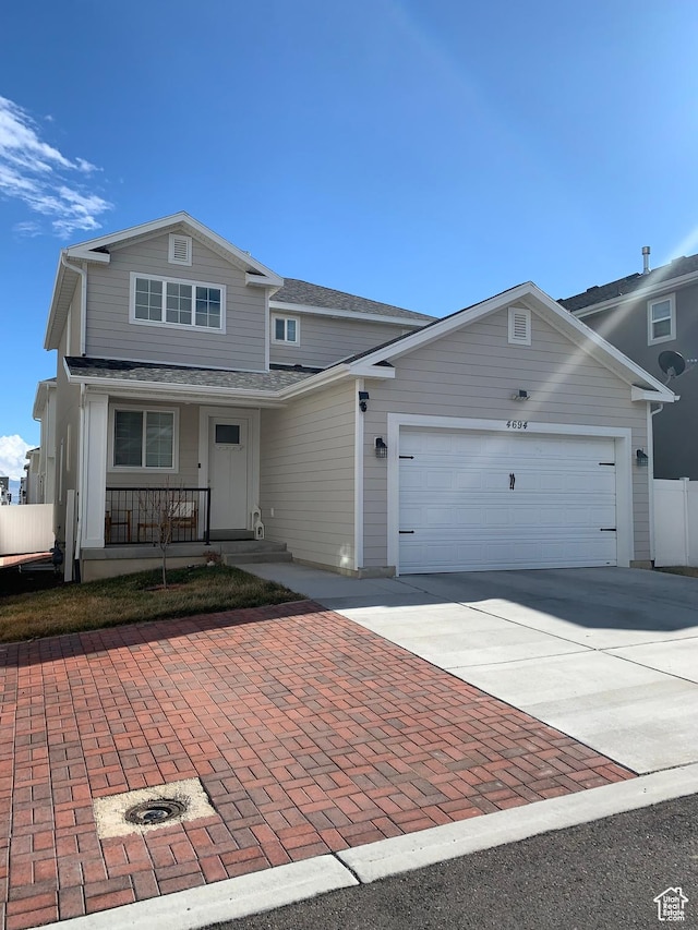 4694 E Lake Corner Dr, Eagle Mountain, UT 84005 - traditional-style home featuring concrete driveway, a porch, a garage, and a shingled roof