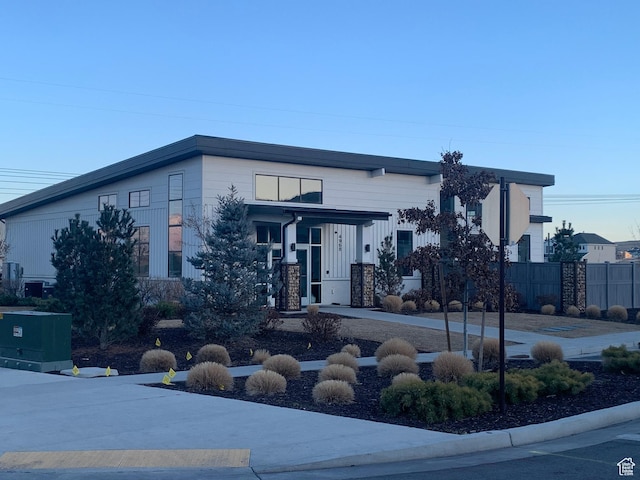 4694 E Lake Corner Dr, Eagle Mountain, UT 84005 - view of front of property with stone siding, cooling unit, and fence
