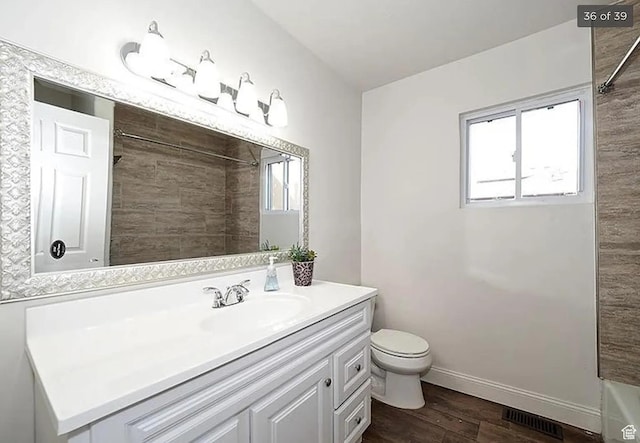 bathroom featuring vanity, hardwood / wood-style floors, and toilet