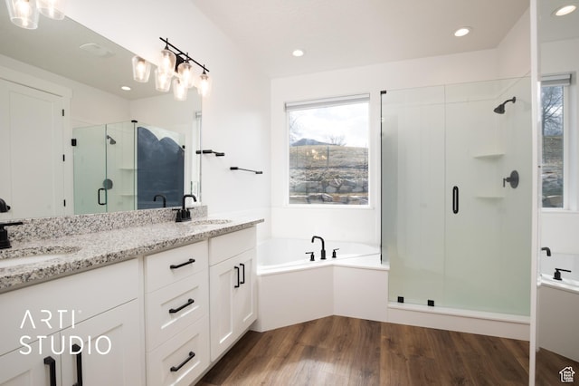 429 W Olympic Ln, Elk Ridge, UT 84651 - bathroom featuring a stall shower, a wealth of natural light, a sink, and wood finished floors