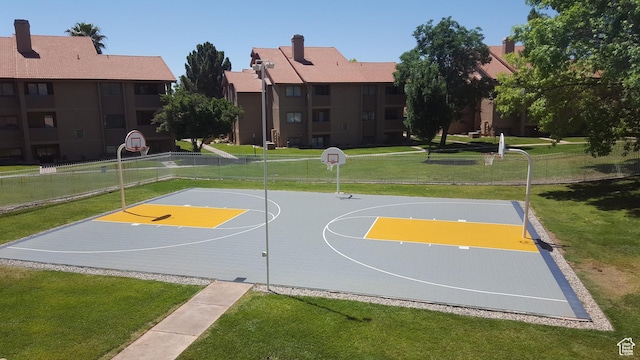 view of sport court featuring a lawn