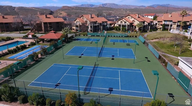 view of tennis court featuring a mountain view