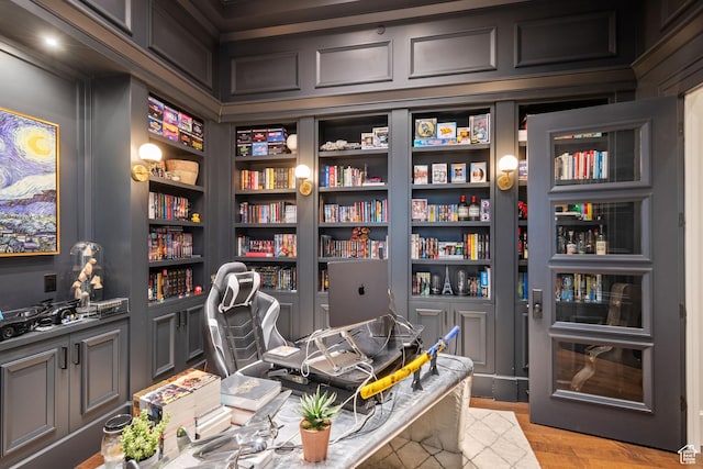 home office with light hardwood / wood-style floors and built in features