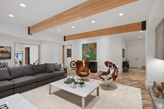 living room with beam ceiling and light hardwood / wood-style flooring