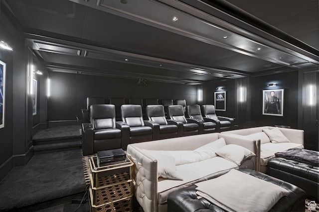 home theater room featuring beamed ceiling and carpet flooring