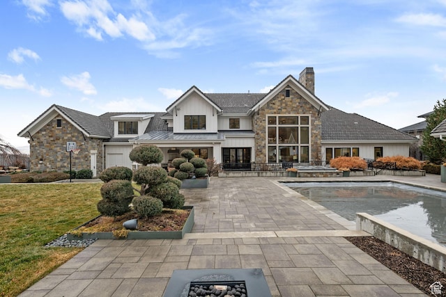 exterior space with a fire pit, a patio area, and a lawn