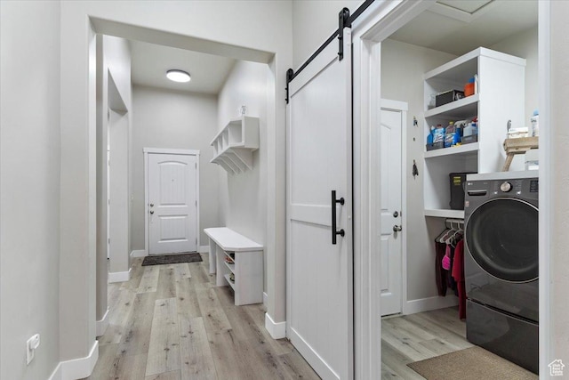 7160 S 1100 E, South Weber, UT 84405 - washroom with a barn door, light hardwood / wood-style floors, and washer / clothes dryer