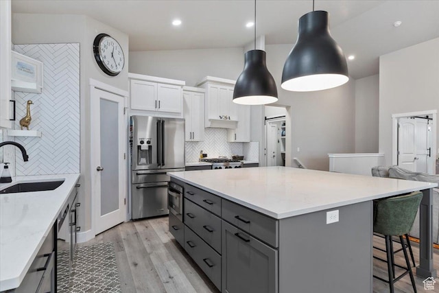 7160 S 1100 E, South Weber, UT 84405 - kitchen with sink, white cabinetry, stainless steel appliances, light stone counters, and decorative light fixtures