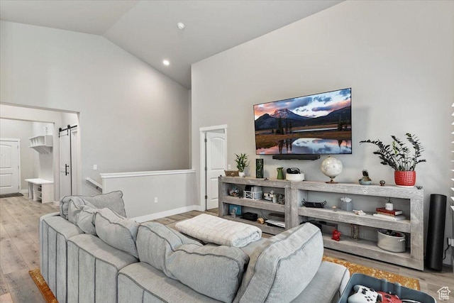 7160 S 1100 E, South Weber, UT 84405 - living room with a barn door, high vaulted ceiling, and light wood-type flooring