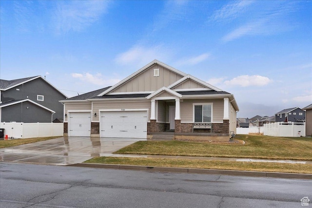 craftsman-style home with a garage and a front yard