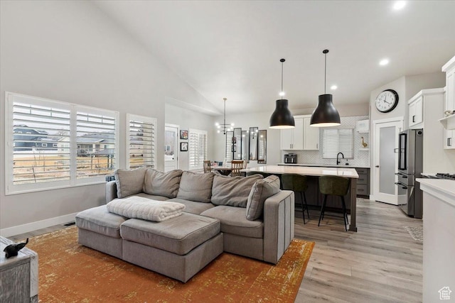 7160 S 1100 E, South Weber, UT 84405 - living room featuring high vaulted ceiling, sink, and light hardwood / wood-style floors