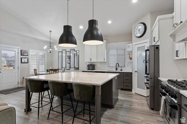 7160 S 1100 E, South Weber, UT 84405 - kitchen featuring white cabinetry, stainless steel appliances, decorative light fixtures, and a center island