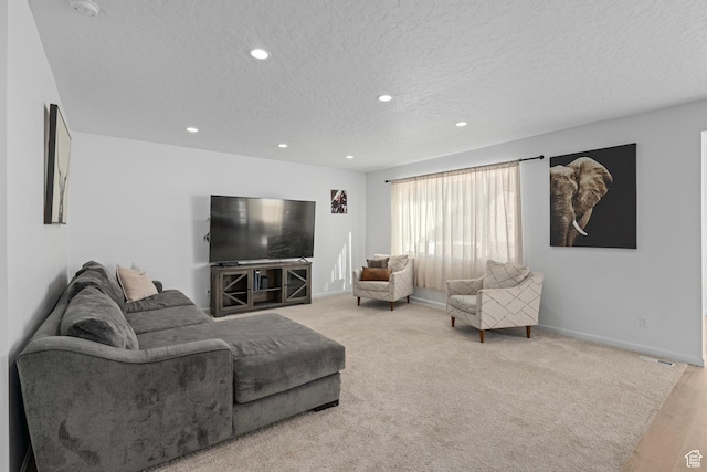 living room featuring light colored carpet and a textured ceiling