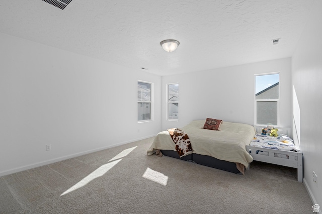 carpeted bedroom featuring a textured ceiling