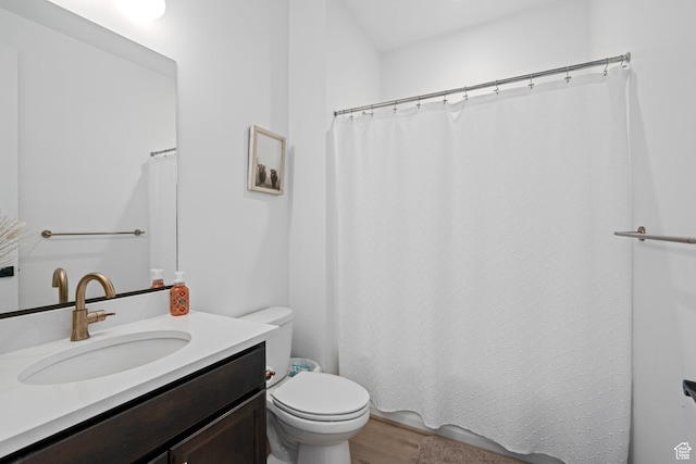 bathroom with vanity, hardwood / wood-style floors, and toilet