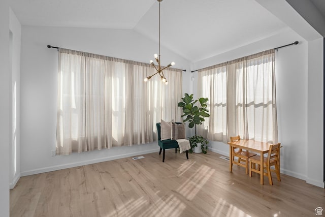living area with vaulted ceiling, light hardwood / wood-style flooring, and a notable chandelier