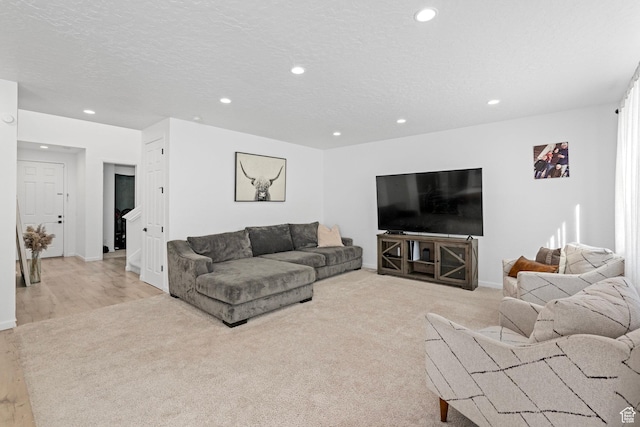 living room with light colored carpet and a textured ceiling