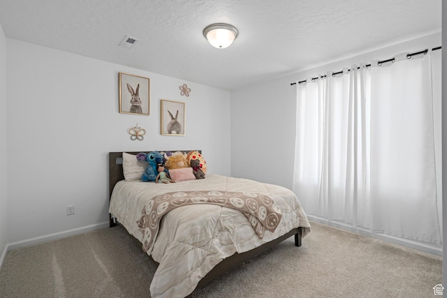 carpeted bedroom with a textured ceiling