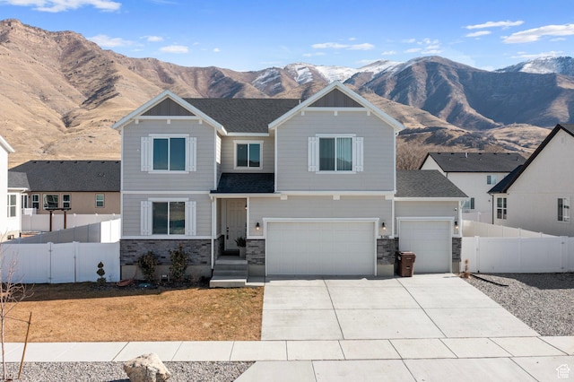 view of front of house featuring a garage and a mountain view