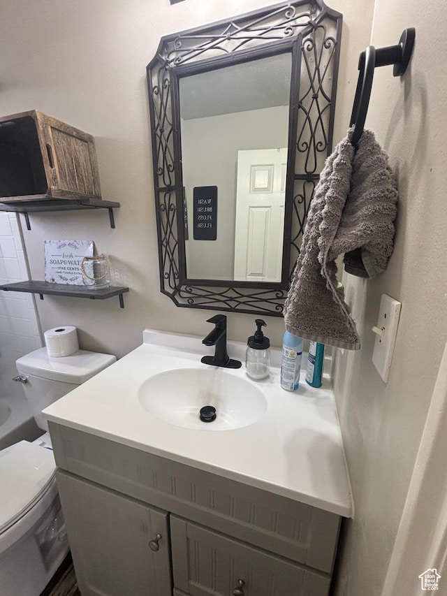 bathroom featuring toilet and vanity