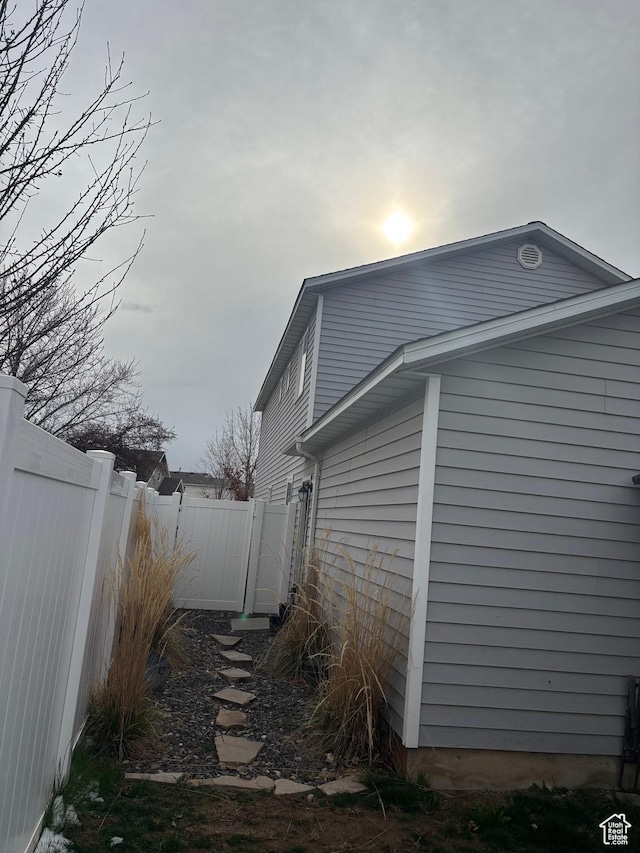 view of side of home featuring fence