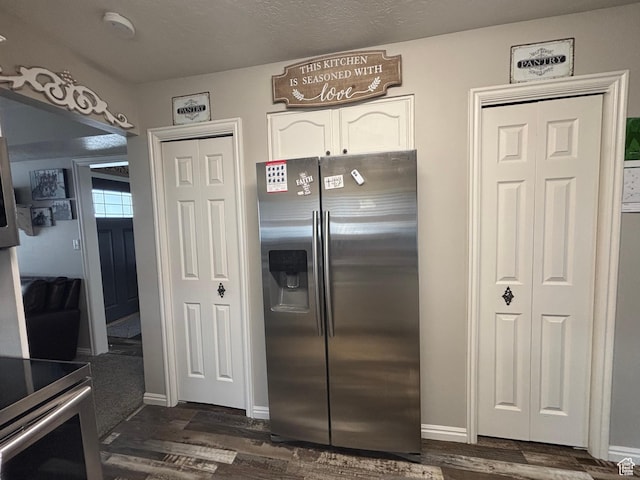 kitchen featuring stainless steel fridge with ice dispenser, white cabinets, dark wood finished floors, and baseboards