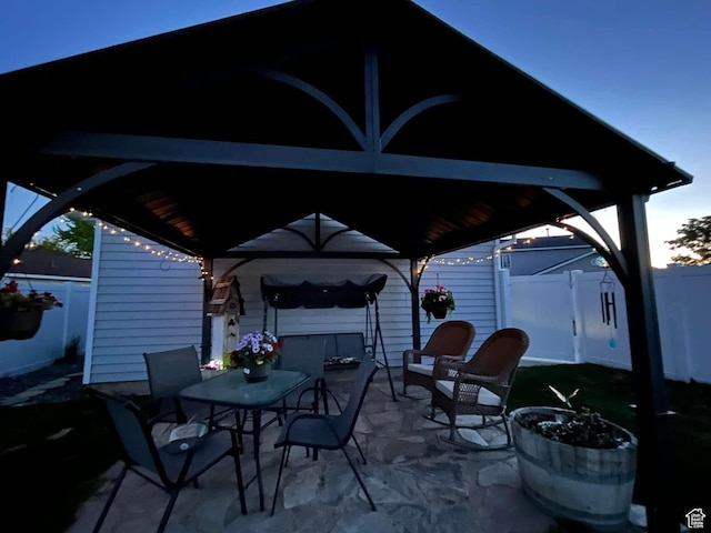 view of patio / terrace featuring a gazebo, fence, and outdoor dining area