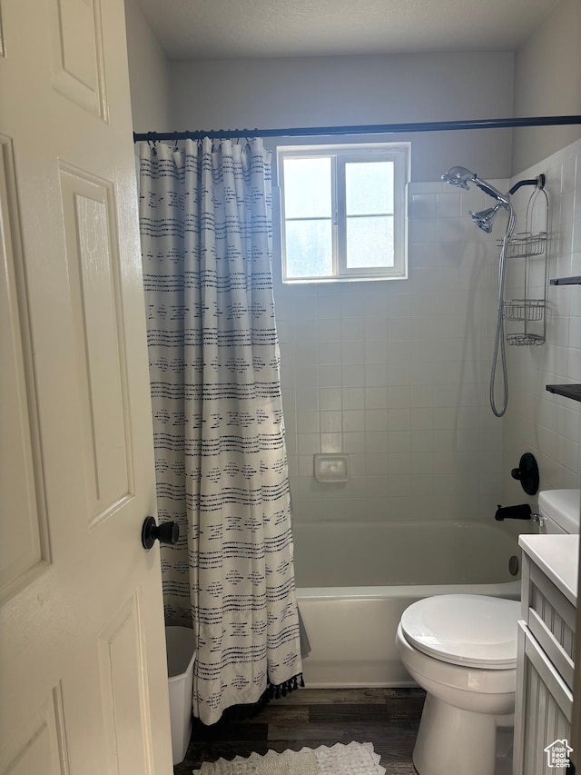 bathroom featuring shower / bathtub combination with curtain, wood finished floors, toilet, and vanity
